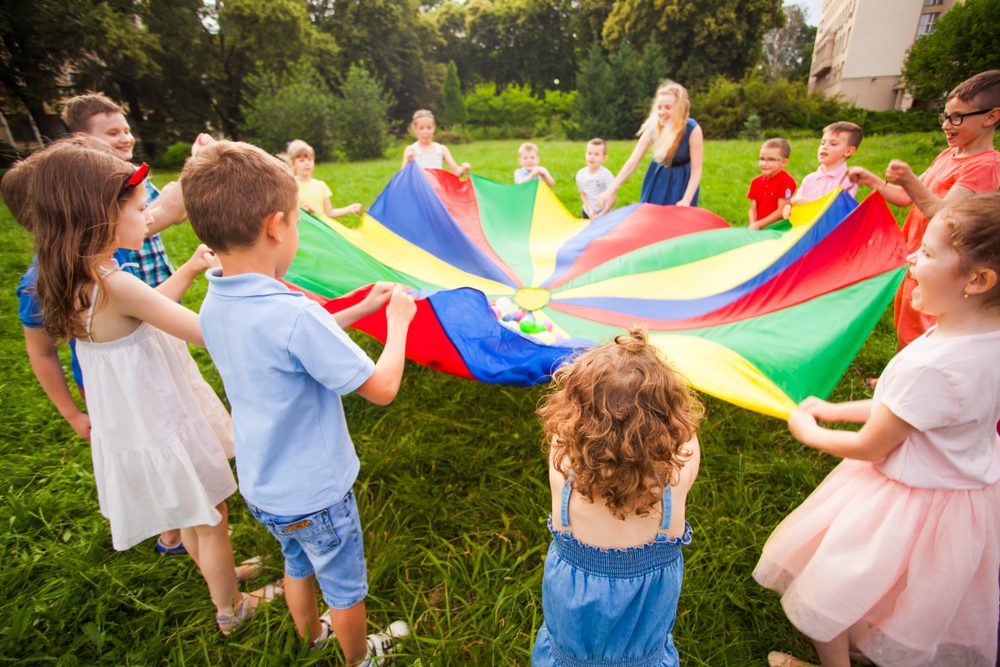 Happy,Kids,Holding,Parachute,During,Funny,Game